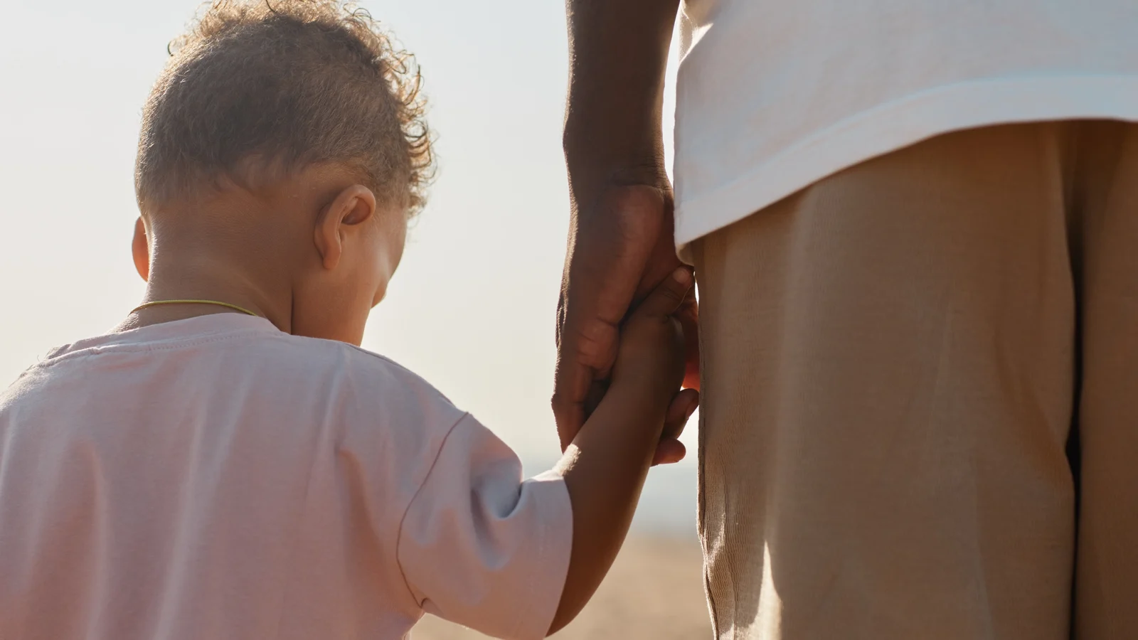 Father holding sons hand
