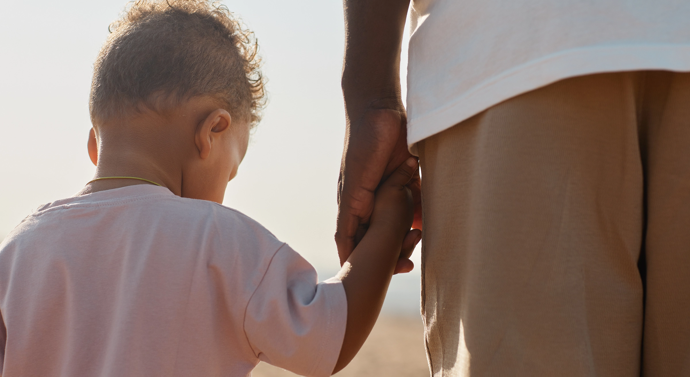 Father holding sons hand
