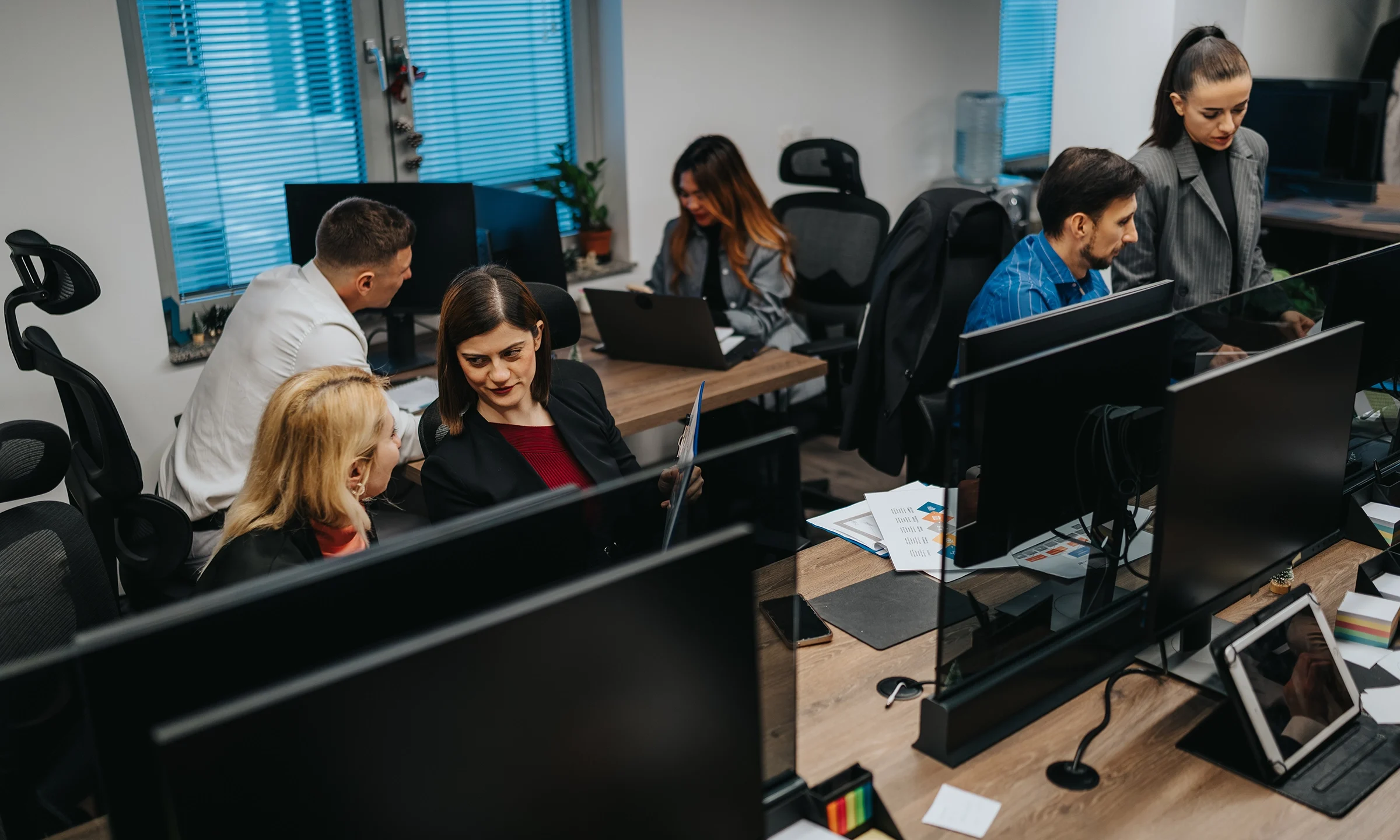 People communicating in busy office
